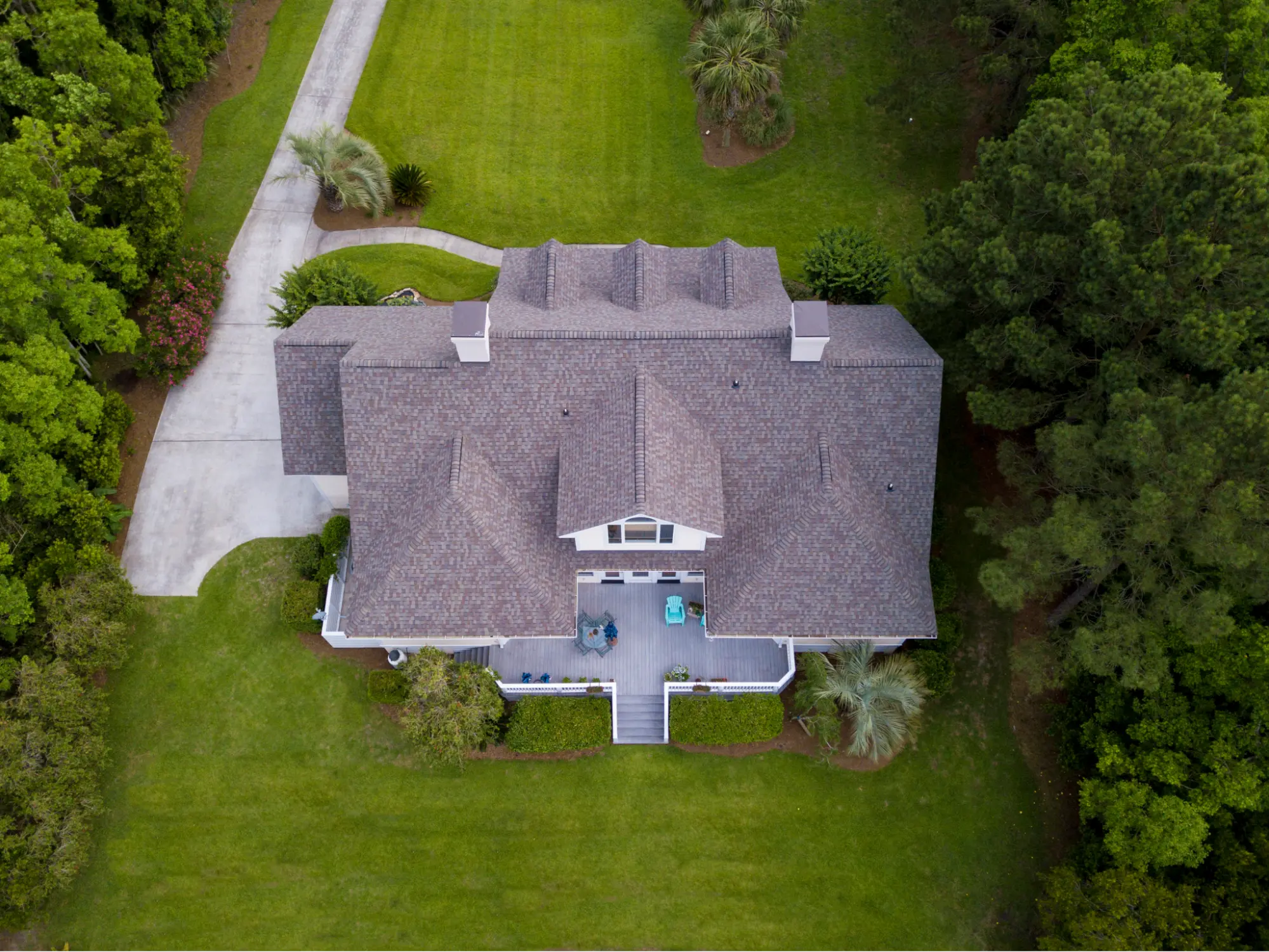 Drone view looking down at large home with shingle roof
